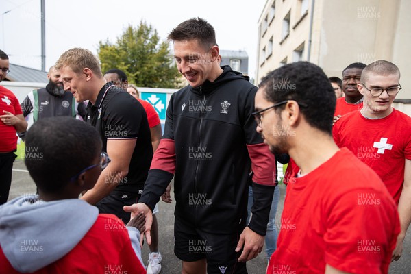 041023 - Picture shows the Wales Rugby Team visiting IME Le Rondo Croix Rouge in Versailles, a school for children with disabilities - Josh Adams with pupils