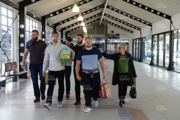 050616 - Wales Rugby Squad Sky Tower Walk -Jake Ball, Josh Turnbull, Samson Lee, Rodri Jones and Sam Warburton help a lady with her shopping and luggage at the ferry port in Auckland on a afternoon off after training