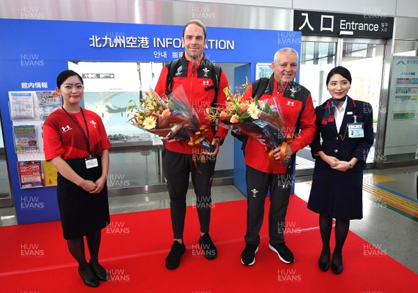 140919 - Wales Rugby Squad Arrive in Kitakyushu - Alun Wyn Jones and Warren Gatland are presented with flowers after arriving in Kitakyushu