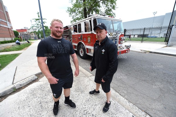 310518 - Wales Rugby Squad Coaching Children in Local Community - Samson Lee and Shaun Edwards with a local fire engine after coaching local school children in Washington DC