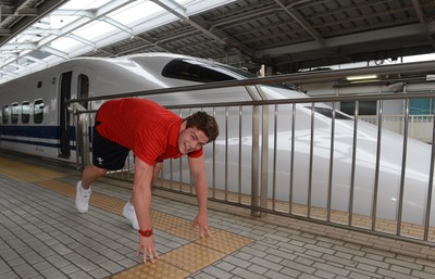 090613 - Wales Squad Travel to Tokyo -Harry Robinson lines up against the famous "Bullet Train" in Osaka on the way to Tokyo