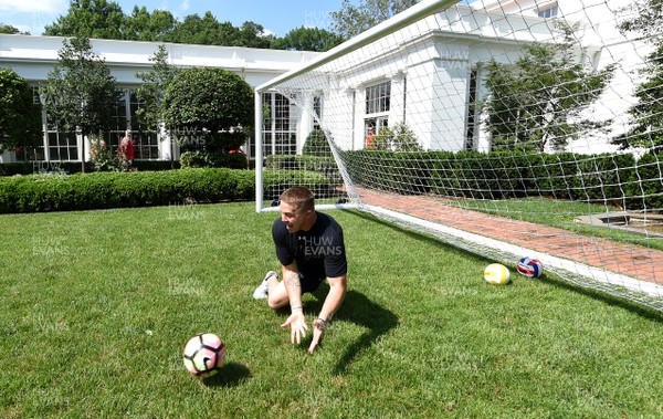 010618 - Wales Rugby Squad Visit The White House - James Davies plays football on the lawn during a tour of The White House
