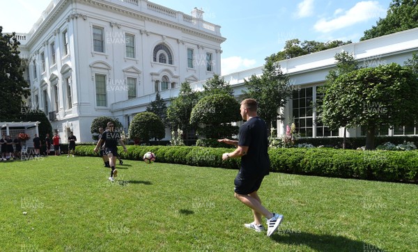 010618 - Wales Rugby Squad Visit The White House - Steff Evans and James Davies play football on the lawn during a tour of The White House