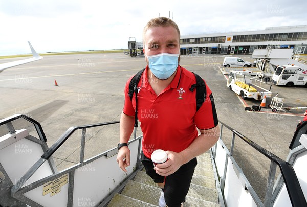 190321 - Wales Rugby team travel from Cardiff Airport to Paris ahead of their final Guinness 6 Nations match against France tomorrow - Tomas Francis smiles as he boards the plane
