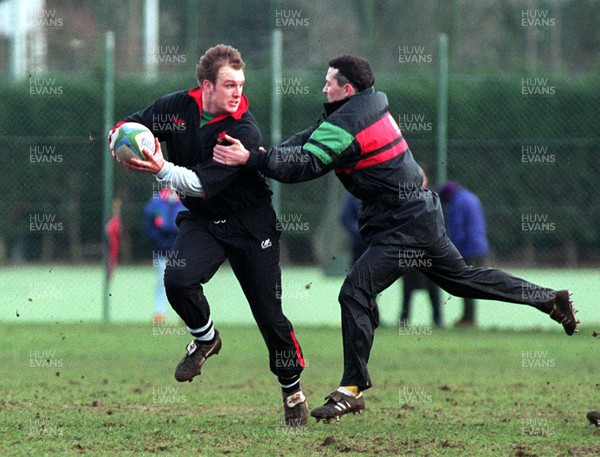 010395 - Wales Rugby Training - Mike Hall is tackled by David Evans during training