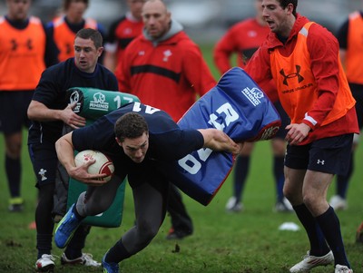 01.12.11 - Wales Rugby Training - George North gets through Shane Williams and Alex Cuthbert during training. 