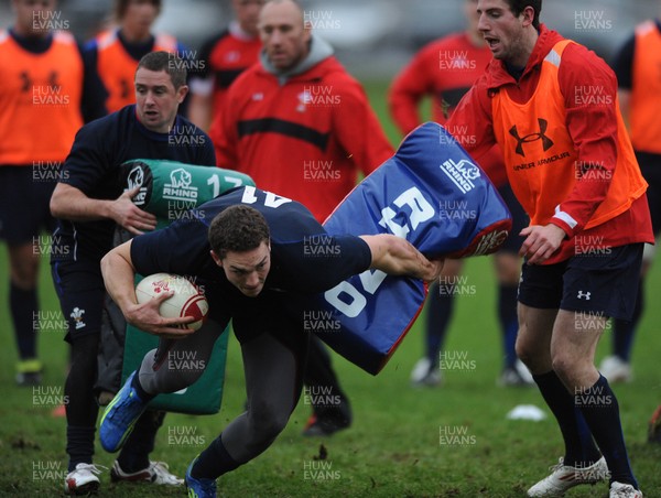 01.12.11 - Wales Rugby Training - George North gets through Shane Williams and Alex Cuthbert during training. 