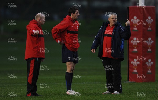 01.12.11 - Wales Rugby Training - Alex Cuthbert talks to head coach Warren Gatland(R) and Neil Jenkins during training. 