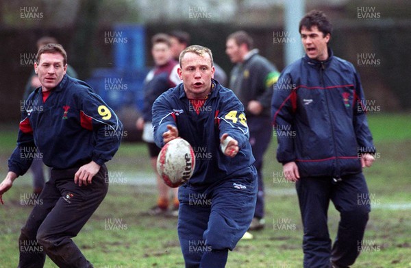 030398 - Wales Rugby Training -  Kingsley Jones passes during training, watched by Alan Bateman (L) and new backs coach Geraint John (R) 