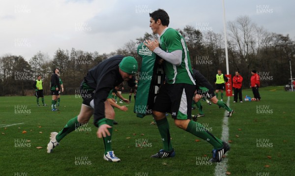 05.11.09 - Wales Rugby Training - Martyn Williams hits James Hooks tackle bag during training. 