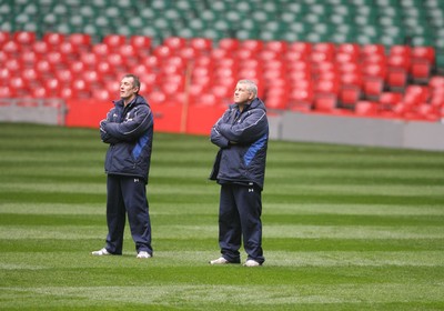 05.11.10 Wales rugby training... Wales coaches Warren Gatland (rt) and Rob Howley (lt) looks skywards during the rain in training... 