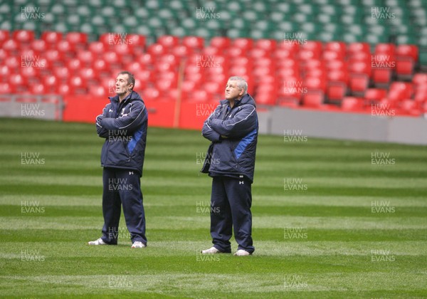 05.11.10 Wales rugby training... Wales coaches Warren Gatland (rt) and Rob Howley (lt) looks skywards during the rain in training... 