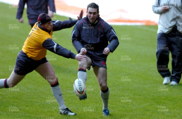 060307 - Wales Rugby Training - Stephen Jones kicks past Rhys Thomas during training 