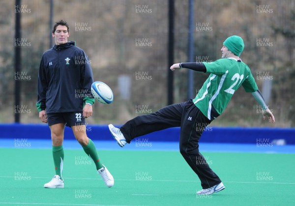 07.02.09 - Wales Rugby Training - Stephen Jones kicks the ball as James Hook looks on during training. 