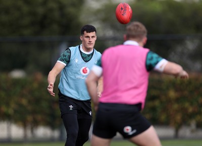 080724 - Wales Rugby enjoy a quick game of Aussie Rules Football in Training in the week ahead of their second test against Australia in Melbourne - Ellis Bevan during training