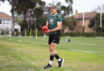 080724 - Wales Rugby enjoy a quick game of Aussie Rules Football in Training in the week ahead of their second test against Australia in Melbourne - Taine Plumtree during training