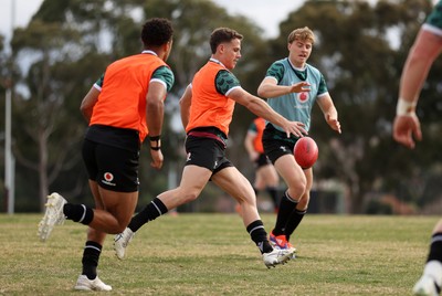 080724 - Wales Rugby enjoy a quick game of Aussie Rules Football in Training in the week ahead of their second test against Australia in Melbourne - Kieran Hardy during training