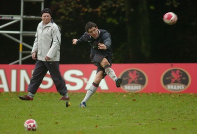 08.11.06 - Wales Rugby Training - Wales Kicking Coach, Neil Jenkins looks on as James Hook takes a kick 