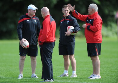 09.08.11 - Wales Rugby Training - Head coach Warren Gatland(R) talks to his assistants Neil Jenkins, Shaun Edwards and Rob Howley during training. 