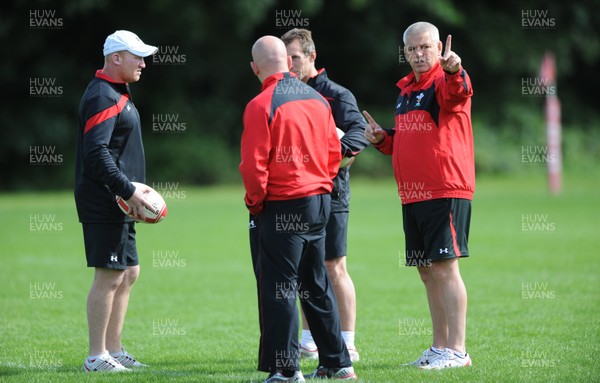 09.08.11 - Wales Rugby Training - Head coach Warren Gatland(R) talks to his assistants Neil Jenkins, Shaun Edwards and Rob Howley during training. 
