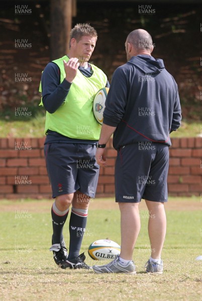 10.06.08 Wales rugby in South Africa... Rhys Thomas discusses tactics with forwards coach Robin McBryde in training.  