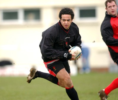 110203 - Wales Rugby Training - Gavin Thomas skips through a gap, watched by team-mate Leigh Davies (rt)