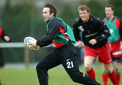 110203 - Wales Rugby Training - Rhys Williams avoids tacklers as he is followed by Dafydd Jones and Mark Jones (rt)