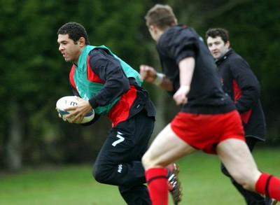 110203 - Wales Rugby Training - Wales Captain Colin Charvis sidesteps as Dafydd Jones arrives to tackle