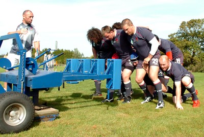 12.09.07 - Wales Rugby World Cup Training - Wales' Forwards coach, Robin Mcbryde puts (l-r)Adam Jones, Matthew Rees, Gethin Jenkins and Martyn Williams through their paces on the scrum machine 