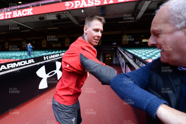130320 - Wales Rugby Training - Liam Williams and Principality Stadium staff member Ian Peploe touch elbows during training