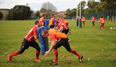 13.06.10 - Wales Rugby Training - Richie Rees hits Will Harries tackle bag during training. 