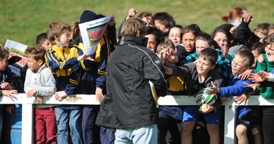 13.09.11 - Wales Rugby Training - Children try to get the attention of a man giving out signed Wales squad pictures at an open training session. 