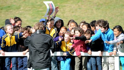 13.09.11 - Wales Rugby Training - Children try to get the attention of a man giving out signed Wales squad pictures at an open training session. 