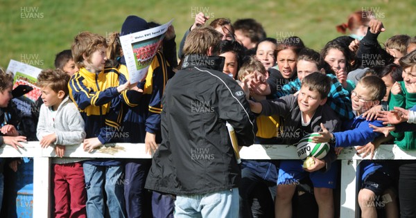 13.09.11 - Wales Rugby Training - Children try to get the attention of a man giving out signed Wales squad pictures at an open training session. 