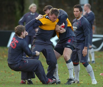 13.11.06 - Wales Rugby Training - Matthew Rees is tackled by Gavin Evans (L) and Ian Gough during training 