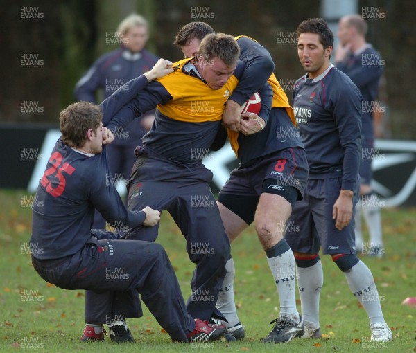 13.11.06 - Wales Rugby Training - Matthew Rees is tackled by Gavin Evans (L) and Ian Gough during training 