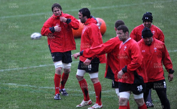 15.06.10 - Wales Rugby Training - Ryan Jones tries to shield the rain during training. 