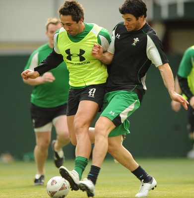 16.03.09 - Wales Rugby Training - Gavin Henson is tackled by Mike Phillips as they play with a football during training. 