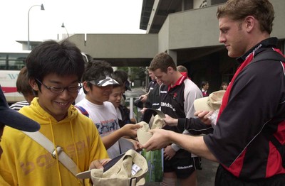 160601 - Wales Rugby Training - Team captain Andy Moore hands out baseball hats to locals who visited the team training session in Tokyo