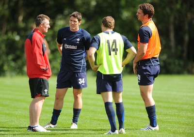16.08.11 - Wales Rugby Training - Wales assistant coach Rob Howley talks to James Hook, Leigh Halfpenny and George North during training. 