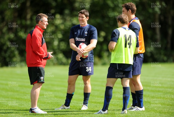 16.08.11 - Wales Rugby Training - Wales assistant coach Rob Howley talks to James Hook, Leigh Halfpenny and George North during training. 
