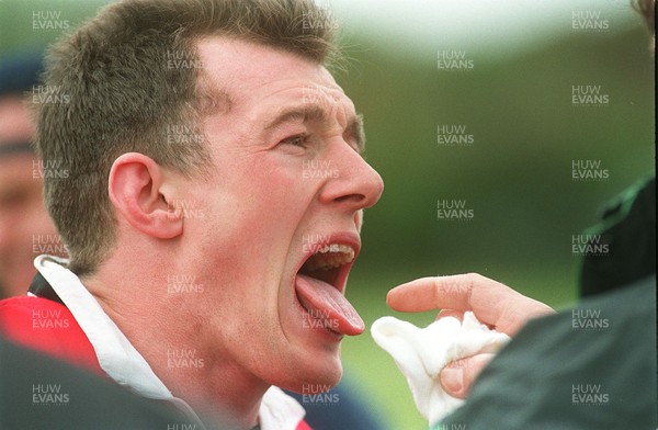 180596 - Wales Rugby Training - Rob Howley receives attention after wasp stung his tongue