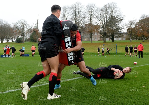 181121 - Wales Rugby Training - Willis Halaholo hits Louis Rees-Zammit tackle bag during training