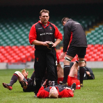 190203 - Wales Rugby Training - Jonathan Humphreys helps Tom Shanklin stretch