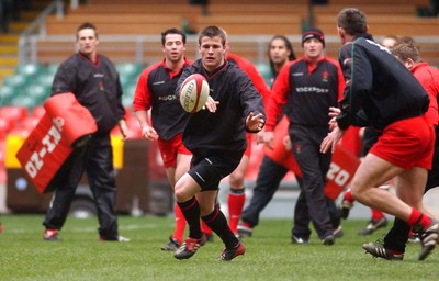 190203 - Wales Rugby Training - Outside half Ceri Sweeney moves the ball at training