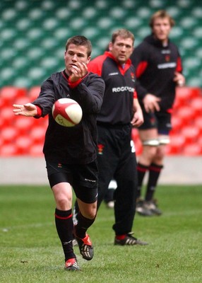 190203 - Wales Rugby Training - Ceri Sweeney passes watched by Jonathan Humphreys, the new Wales captain, at training