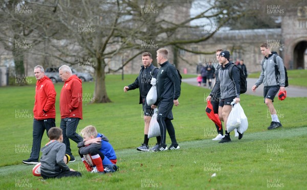 190219 - Wales Rugby Training - Rob Howley, Warren Gatland, Elliot Dee, Gareth Anscombe, Hallam Amos, Gareth Davies and Liam Williams walk past young fans during training