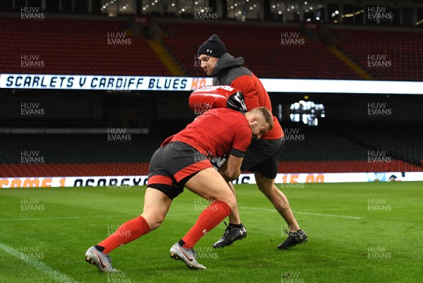 210220 - Wales Rugby Training - Ross Moriarty hits a tackle bag held by Sam Warburton during training
