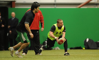 22.02.10 - Wales Rugby Training - Richie Rees gets the ball away as Mike Phillips follows during training. 