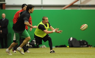 22.02.10 - Wales Rugby Training - Richie Rees gets the ball away as Mike Phillips follows during training. 
